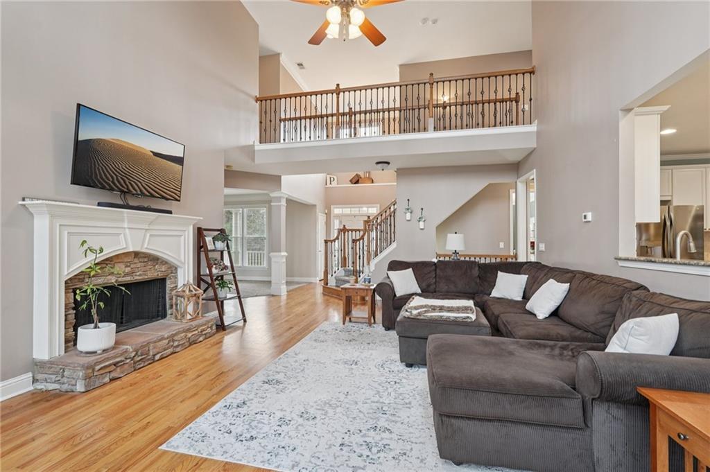 788 Highcrest Drive Acworth, GA 30101 - Photo 12 of 103 a living room with furniture a flat screen tv and a fireplace