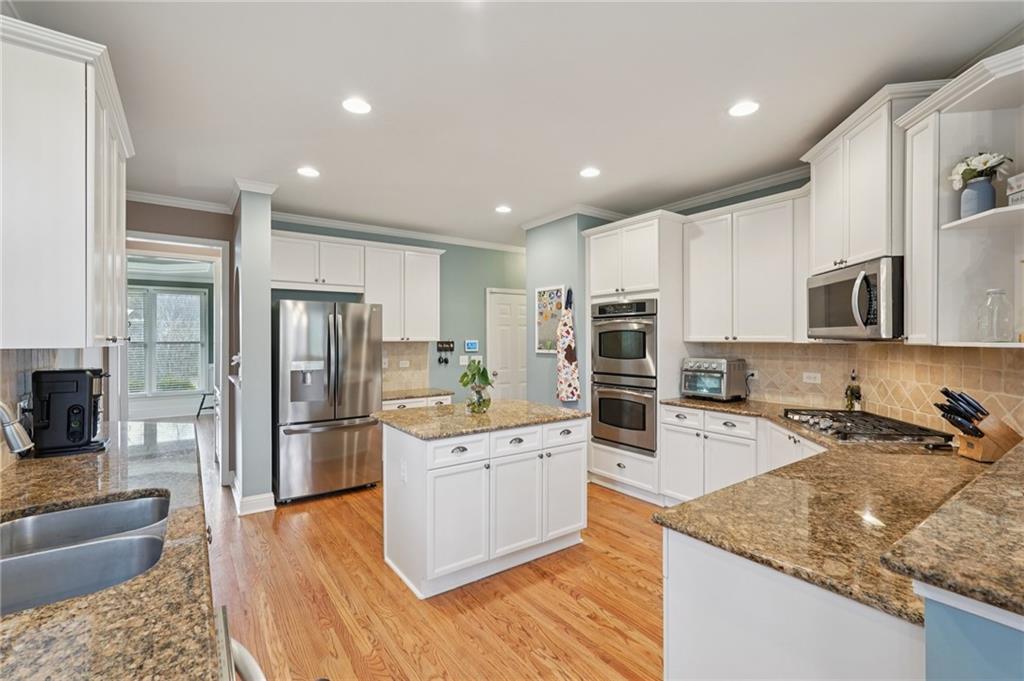 788 Highcrest Drive Acworth, GA 30101 - Photo 22 of 103 a kitchen with stainless steel appliances granite countertop a refrigerator stove microwave and sink