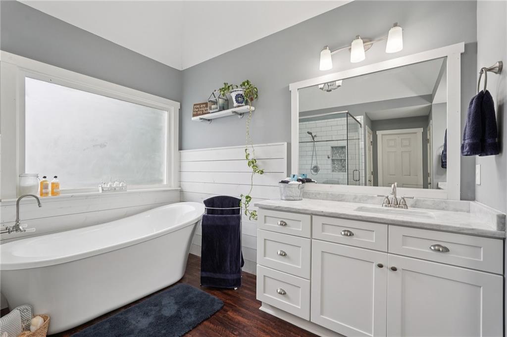 788 Highcrest Drive Acworth, GA 30101 - Photo 57 of 103 a bathroom with a bathtub a double vanity sink and mirror