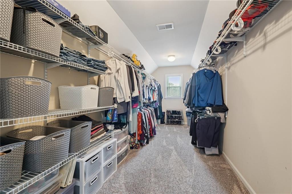 788 Highcrest Drive Acworth, GA 30101 - Photo 61 of 103 a view of walk in closet with clothes