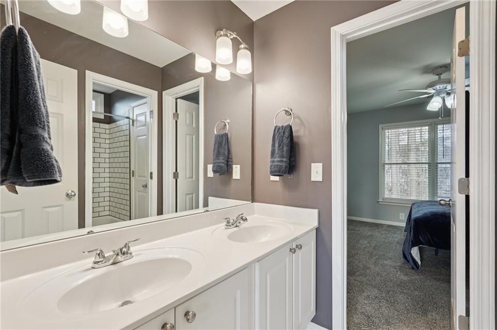 788 Highcrest Drive Acworth, GA 30101 - Photo 66 of 103 a en suite bathroom with a sink a mirror and a shower