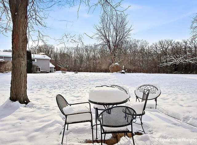 a backyard of a house with table and chairs
