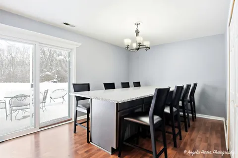 a view of a dining room with furniture wooden floor and chandelier