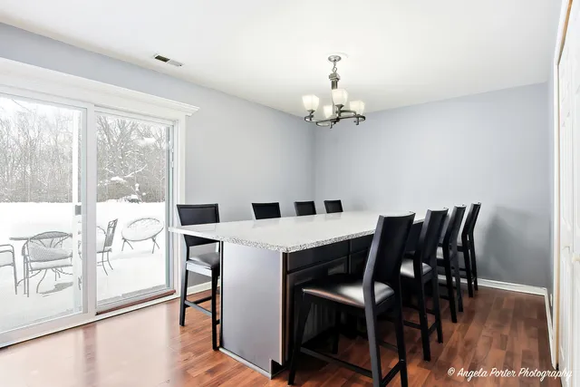 a view of a dining room with furniture wooden floor and chandelier