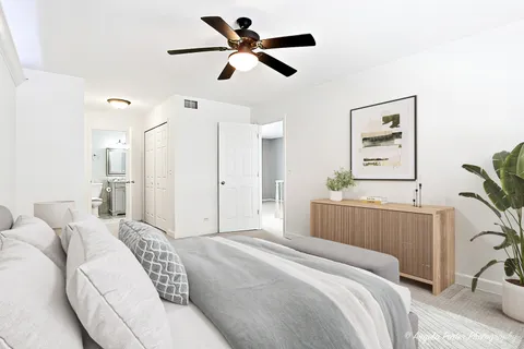 a bedroom with a bed furniture and a large window