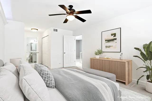 a bedroom with a bed furniture and a large window