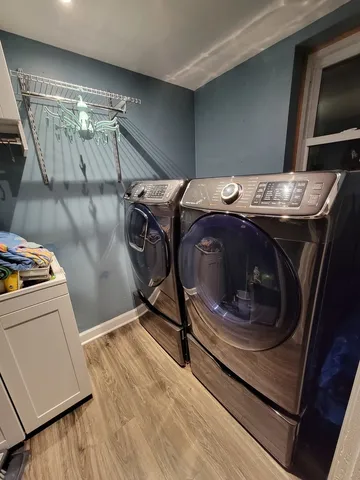 a view of entryway and hall with wooden floor