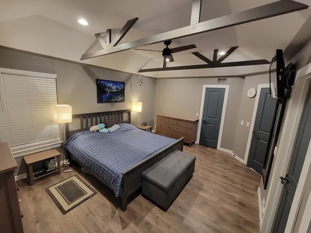 a bedroom with furniture and a chair