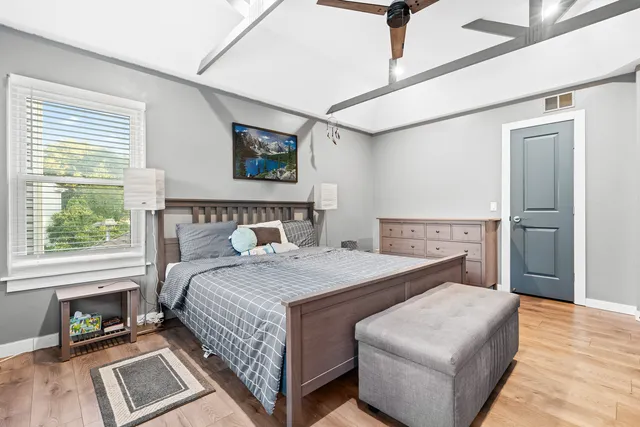 a bedroom with a bed and a window