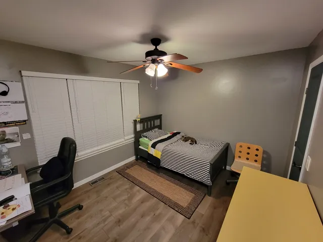 a view of a backyard with wooden fence