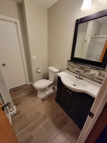 an aerial view of residential house with outdoor space and trees all around