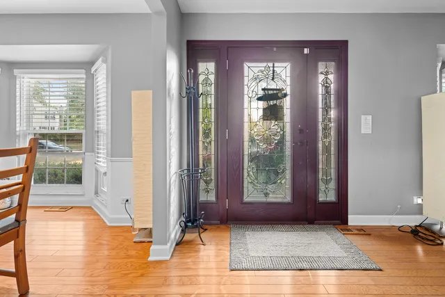 a dining room with table chairs and wooden floor