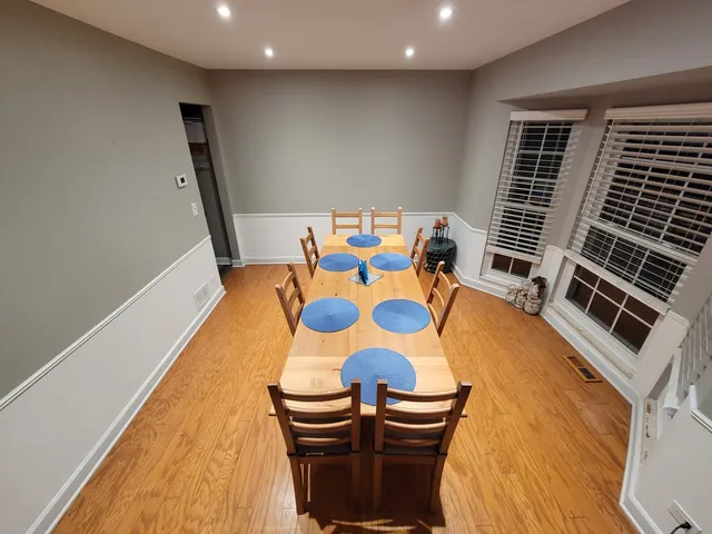 a kitchen with stainless steel appliances granite countertop a stove top oven a sink dishwasher and cabinets with wooden floor