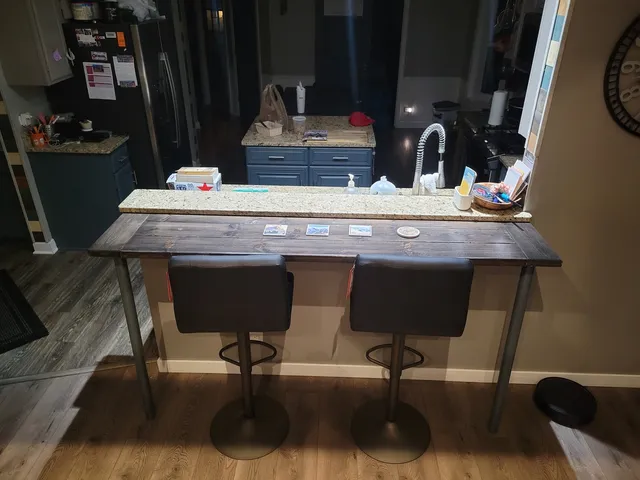 a kitchen with granite countertop a stove and a microwave