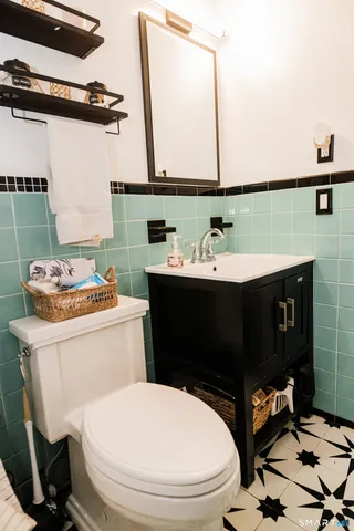 a bathroom with a sink toilet and mirror
