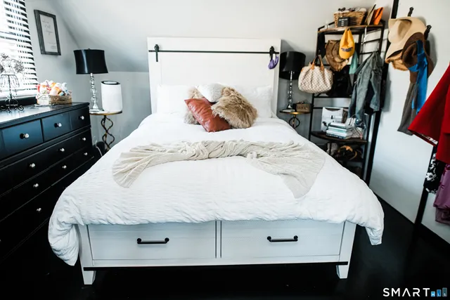 a bedroom with a bed and wooden floor