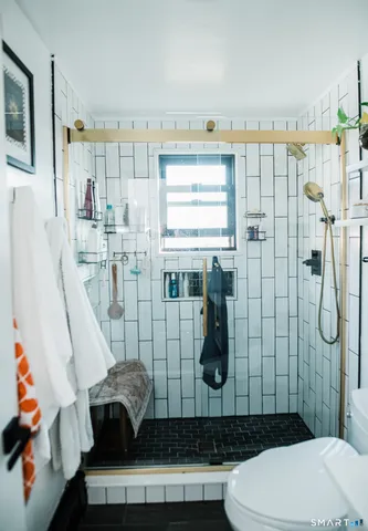 a bathroom with a toilet and shower