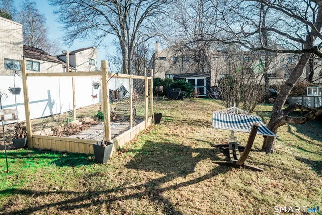 a view of a chair and table in backyard