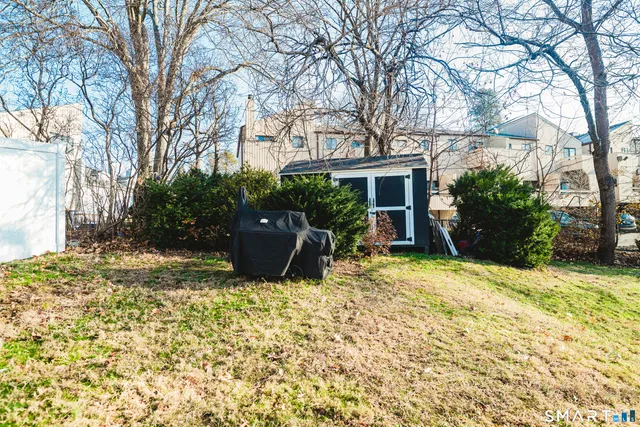 a view of a house with backyard and sitting area