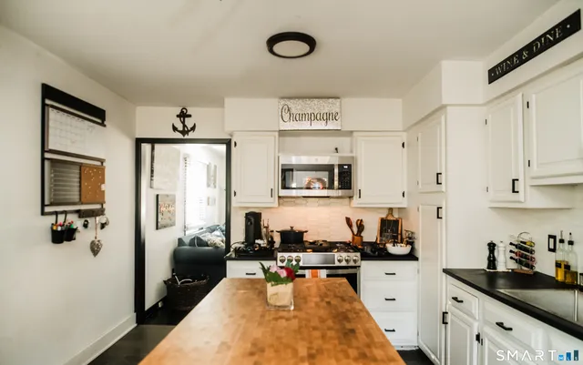 a kitchen with stainless steel appliances a stove sink microwave and cabinets