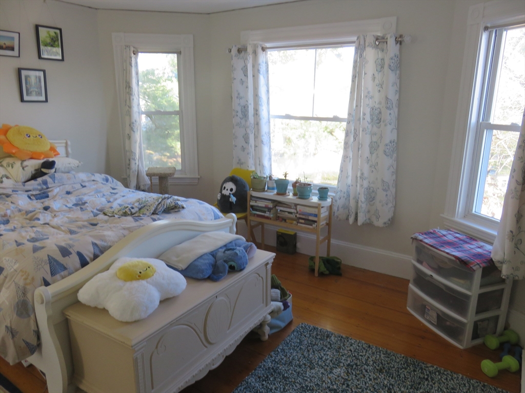 105 Plympton Street, Unit 2 Waltham, MA 02451 - Photo 11 of 27 a bedroom with a bed and a window