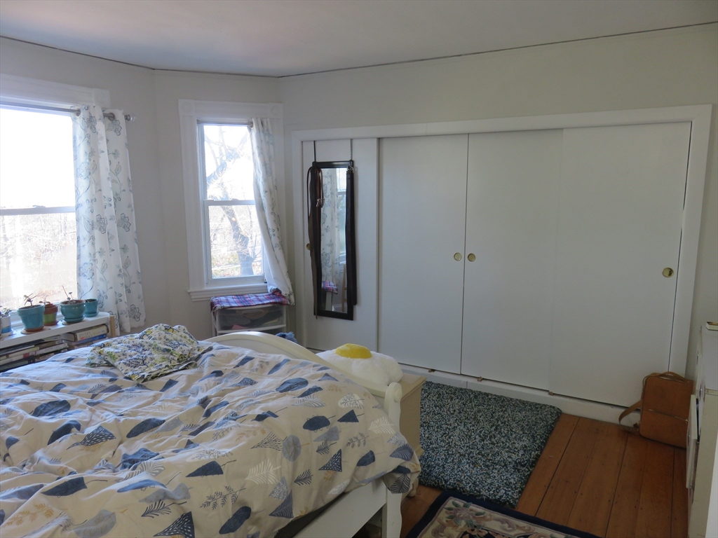 105 Plympton Street, Unit 2 Waltham, MA 02451 - Photo 12 of 27 a bedroom with a bed and a window