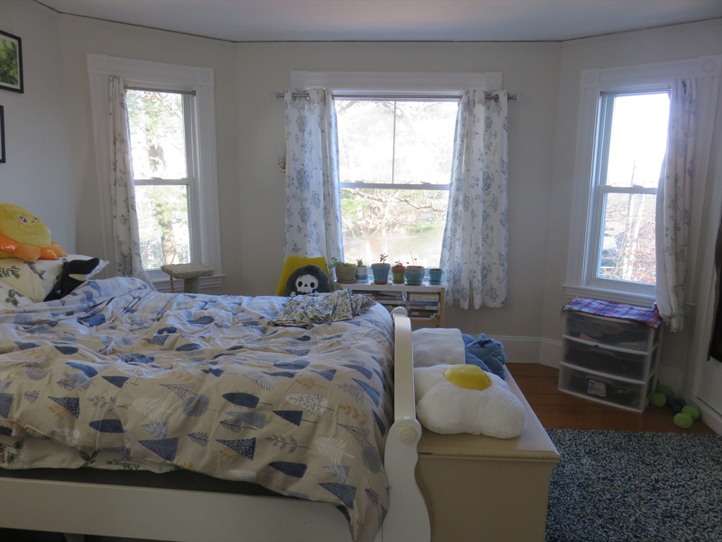 105 Plympton Street, Unit 2 Waltham, MA 02451 - Photo 13 of 27 a bedroom with a bed and window