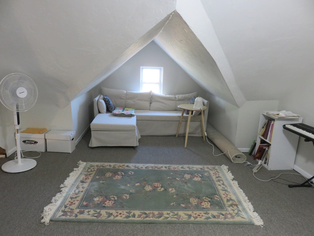 105 Plympton Street, Unit 2 Waltham, MA 02451 - Photo 14 of 27 a living room with furniture and a rug