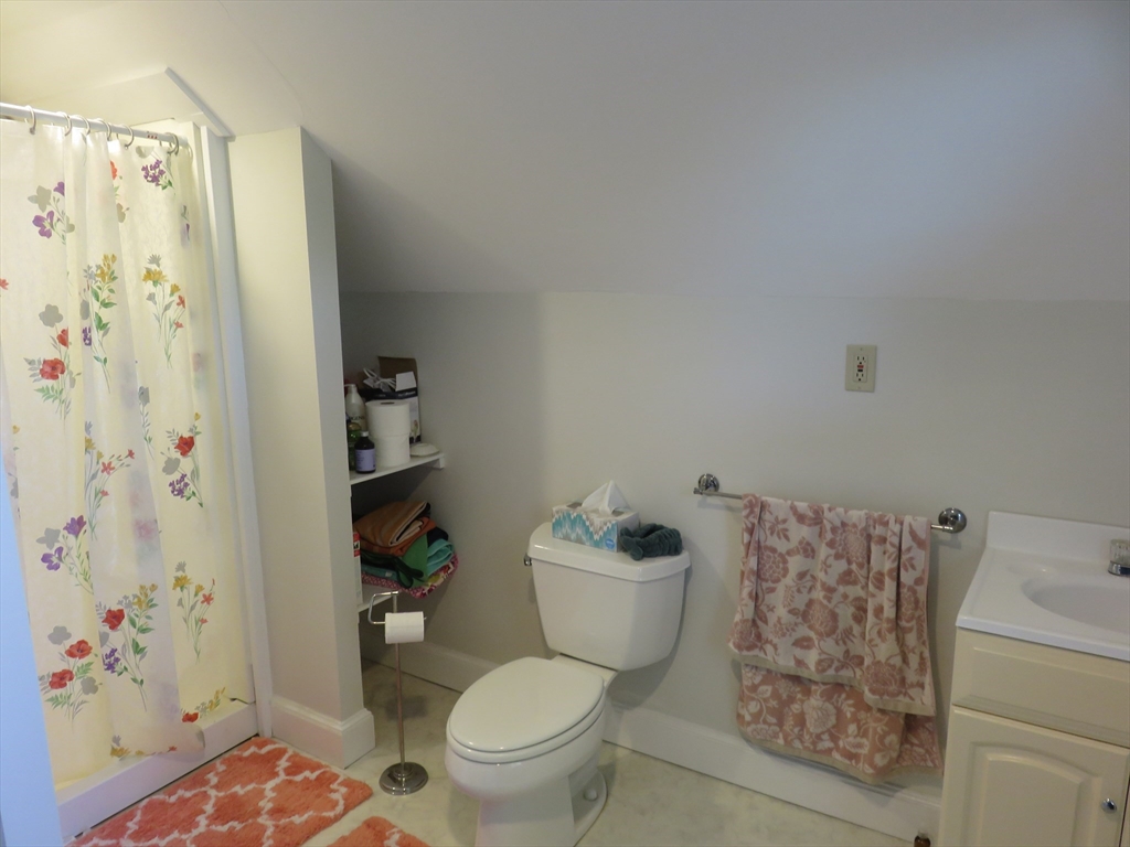 105 Plympton Street, Unit 2 Waltham, MA 02451 - Photo 18 of 27 a white toilet sitting next to a bathroom sink