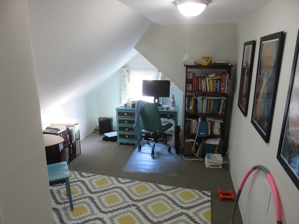 105 Plympton Street, Unit 2 Waltham, MA 02451 - Photo 21 of 27 a living room with furniture and a book shelf