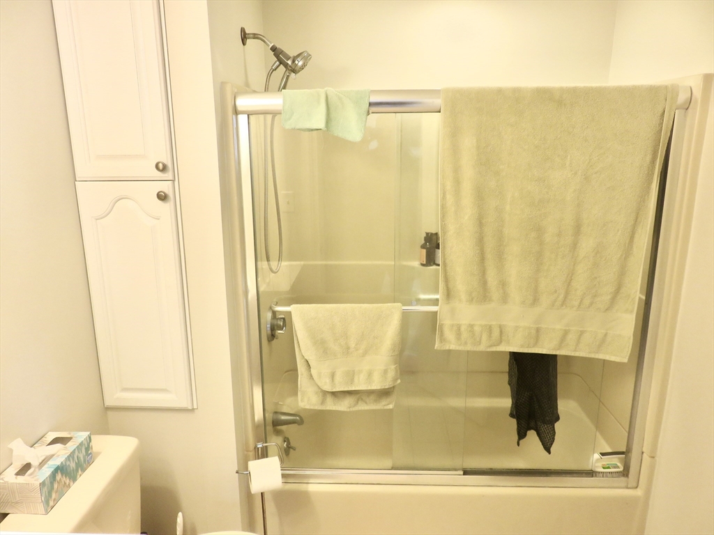 105 Plympton Street, Unit 2 Waltham, MA 02451 - Photo 24 of 27 a bathroom with a bathtub