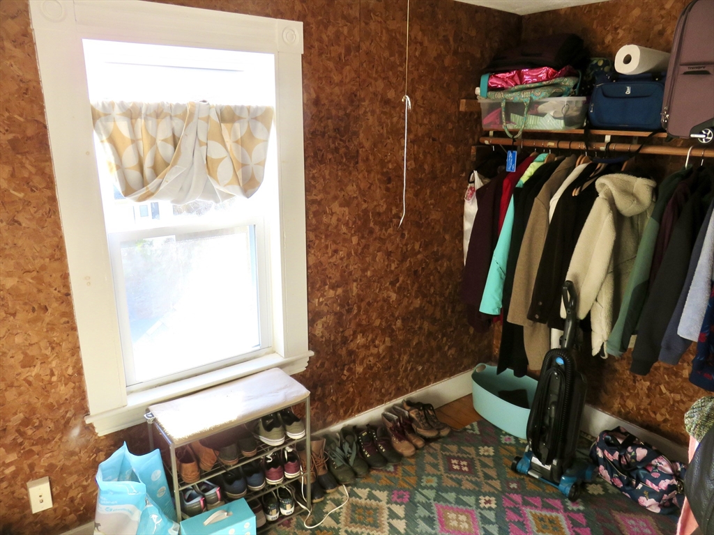 105 Plympton Street, Unit 2 Waltham, MA 02451 - Photo 26 of 27 a view of walk in closet with clothes and shoes