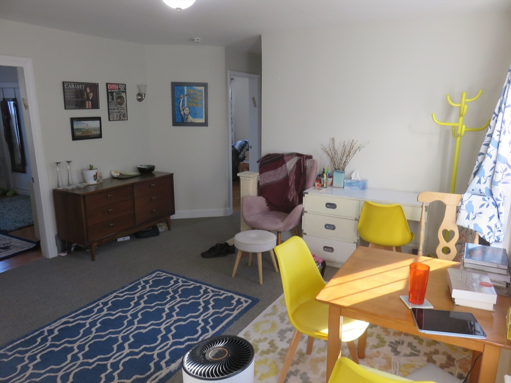 105 Plympton Street, Unit 2 Waltham, MA 02451 - Photo 6 of 27 a living room with furniture rug and a window