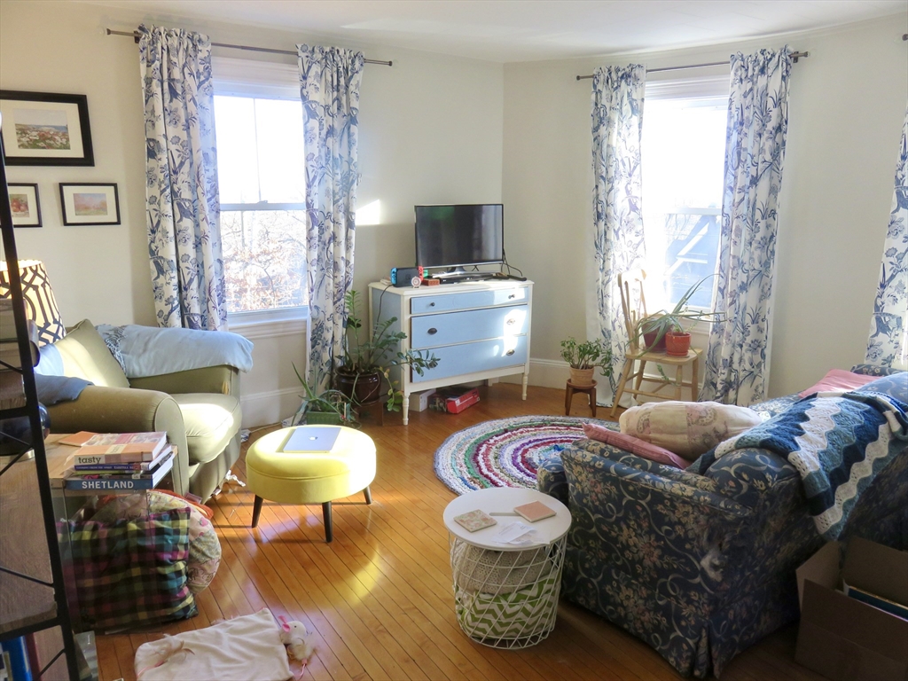 105 Plympton Street, Unit 2 Waltham, MA 02451 - Photo 7 of 27 a living room with furniture and a flat screen tv