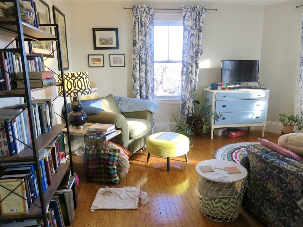105 Plympton Street, Unit 2 Waltham, MA 02451 - Photo 9 of 27 a living room with furniture and a flat screen tv