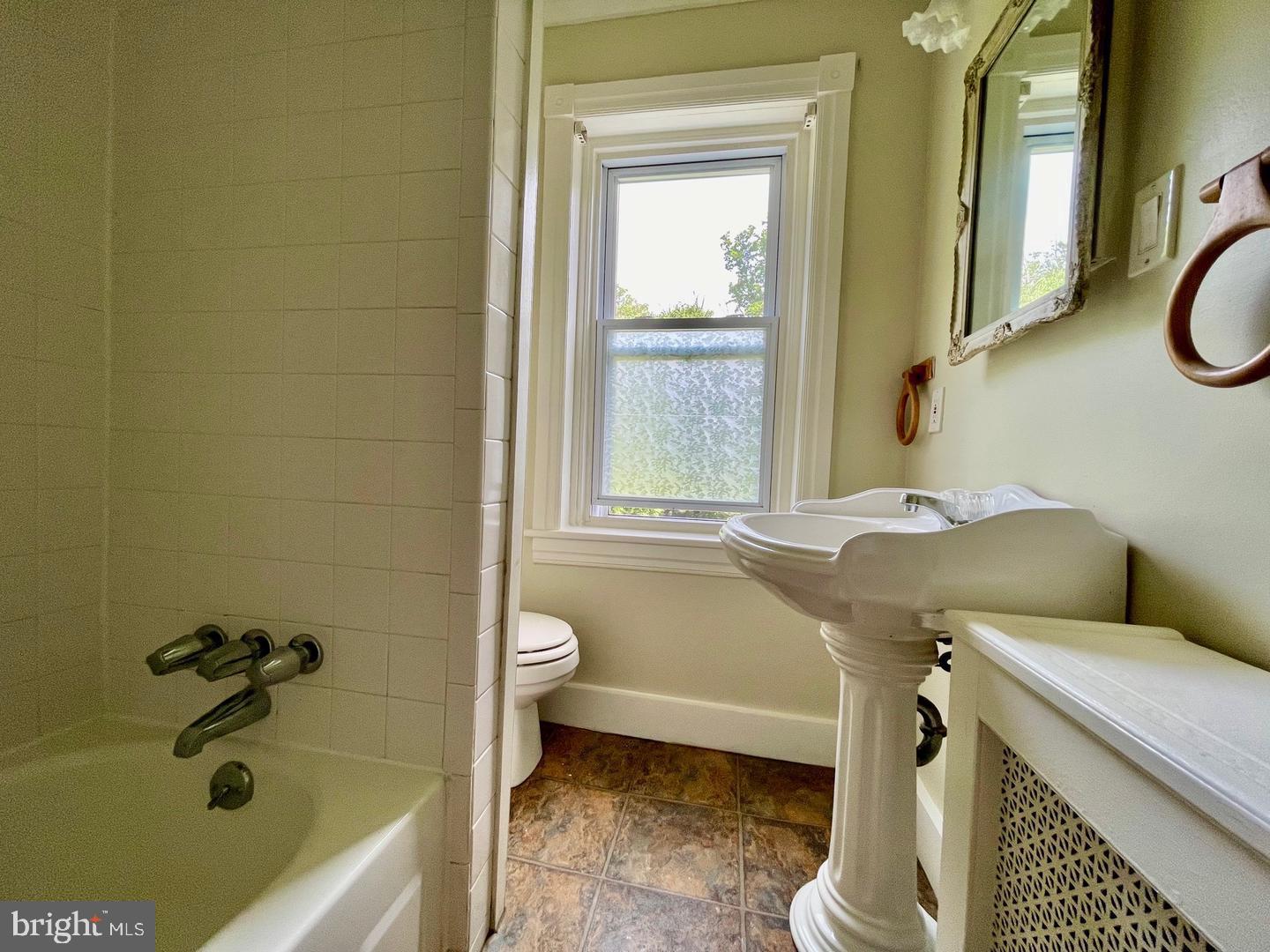 692 Lenni Road Aston, PA 19014 - Photo 13 of 28 a bathroom with a sink a toilet and a bathtub
