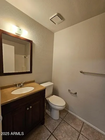 an empty room with a ceiling fan and window