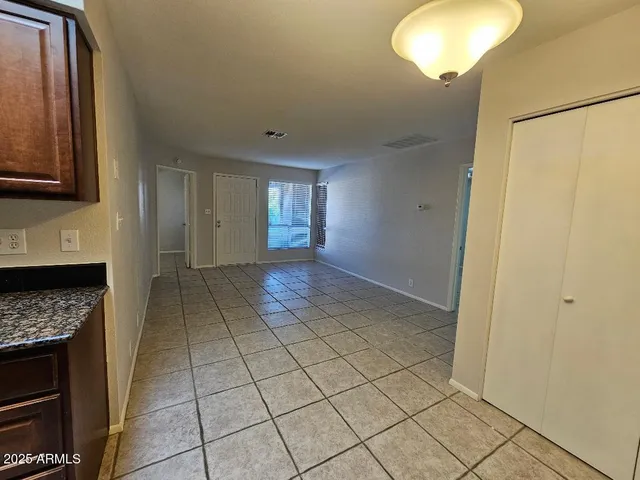 a view of an empty room and a window