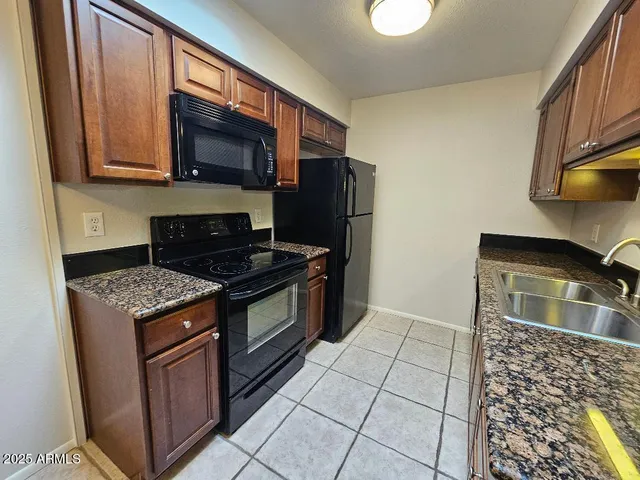a kitchen with stainless steel appliances a refrigerator and a stove top oven