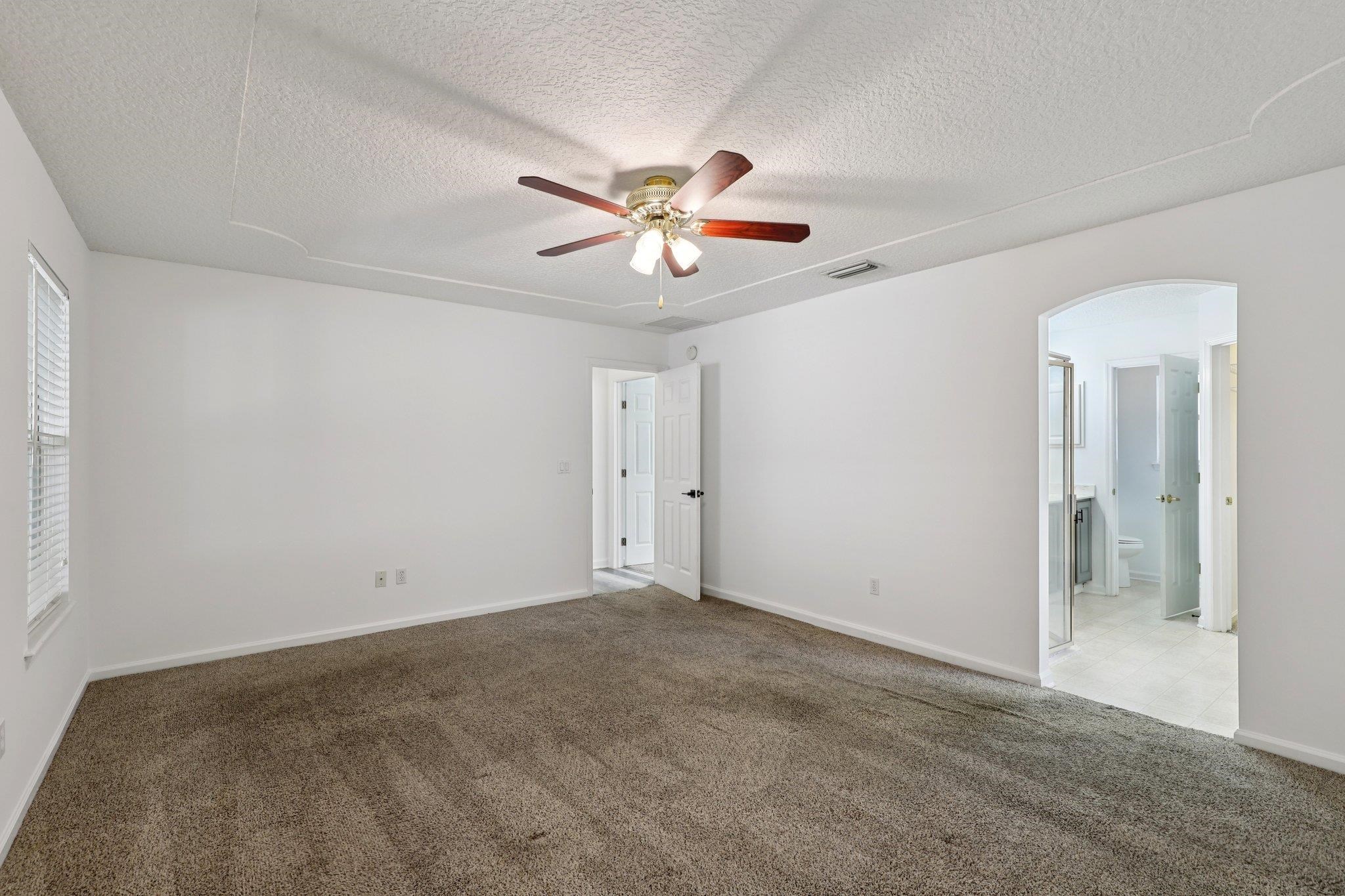 1821 Keswick Road St. Augustine, FL 32084 - Photo 22 of 57 a view of a room with a ceiling fan and a window