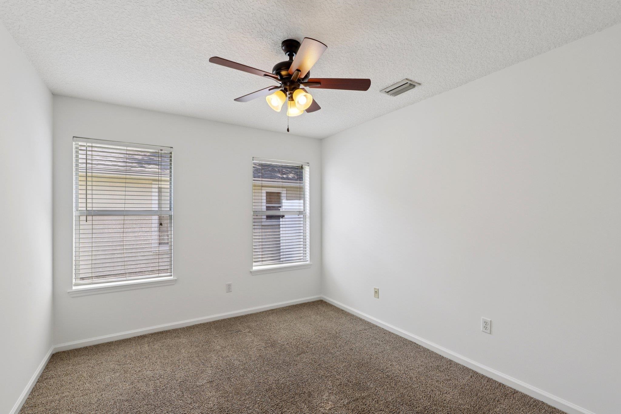 1821 Keswick Road St. Augustine, FL 32084 - Photo 32 of 57 an empty room with windows and fan