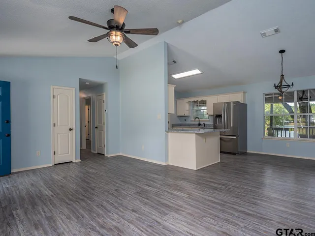 a view of kitchen with refrigerator and window