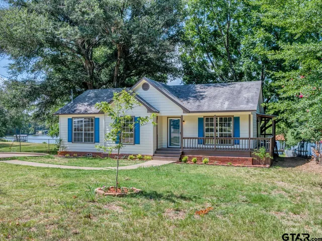 a house view with a sitting space and garden
