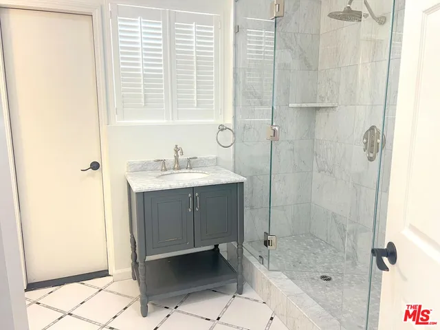 a bathroom with a shower and a sink