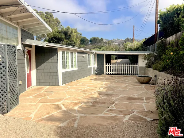 a view of a house with a wooden deck
