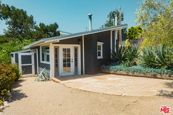 a front view of house with yard outdoor seating and barbeque oven
