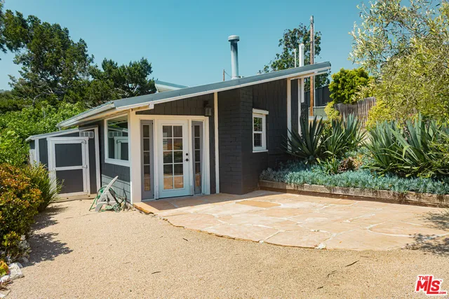 a front view of house with yard outdoor seating and barbeque oven