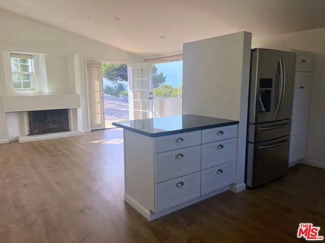 a kitchen with a refrigerator and a cabinets