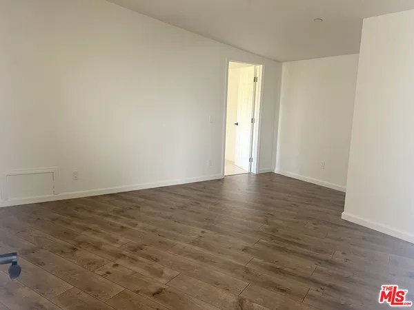 a view of an empty room and wooden floor