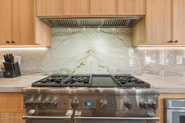 a bathroom with a sink a mirror and a potted plant